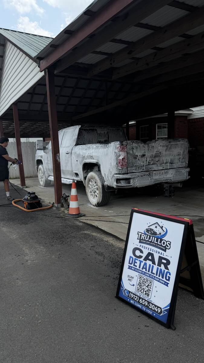 Foam-washed Chevrolet Silverado under a carport